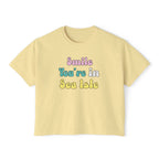 Yellow t-shirt with 'Smile You're in Sea Isle' text on a white background
