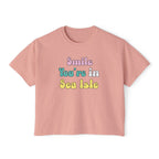 Pink t-shirt with 'Smile You're in Sea Isle' text on a white background