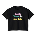 Black t-shirt with colorful text 'Smile You're in Sea Isle' on a white background