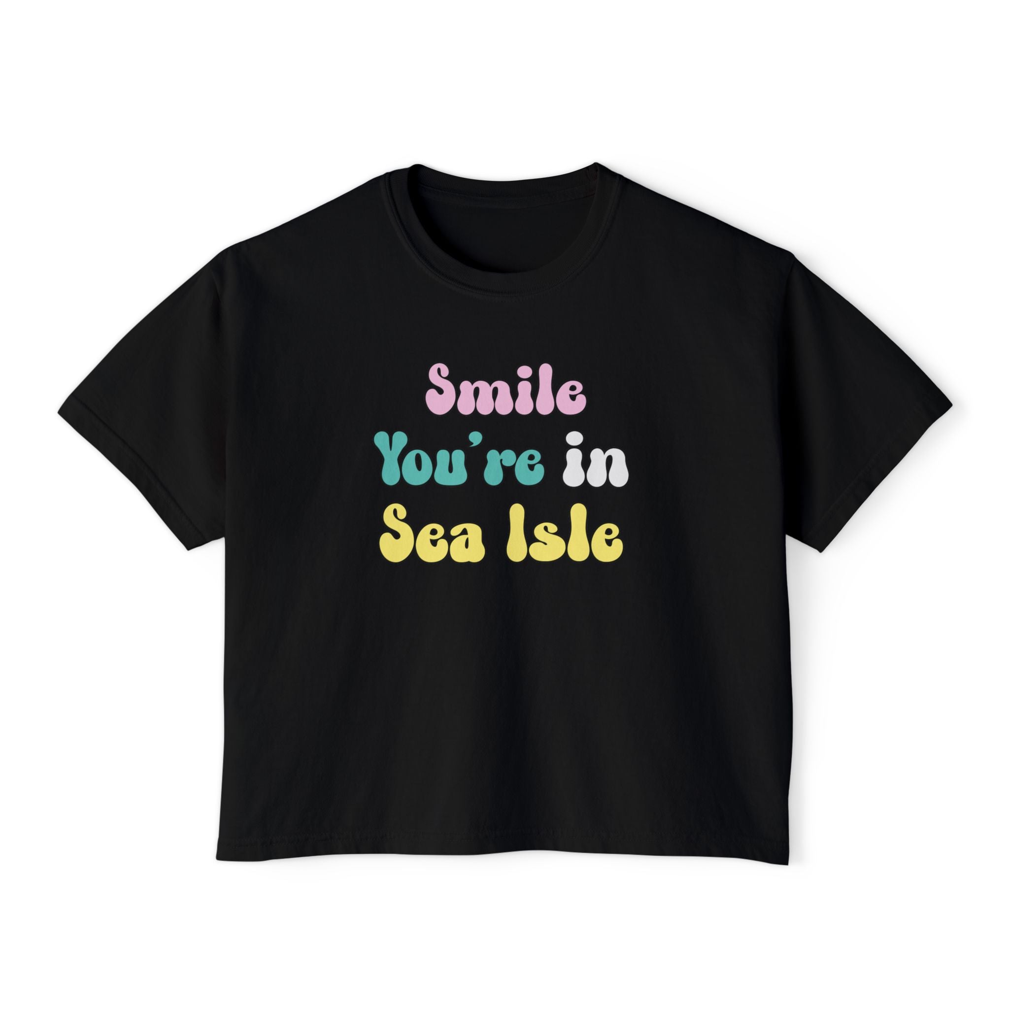 Black t-shirt with colorful text 'Smile You're in Sea Isle' on a white background