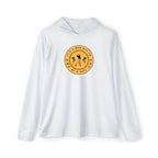 A man wearing a white long-sleeved hoodie with text and graphic print in the center, standing on a golf course.