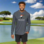A man wearing a gray golf performance hoodie with long sleeves, celebrating Kiawah Island South Carolina, standing on a golf course in South Carolina.
