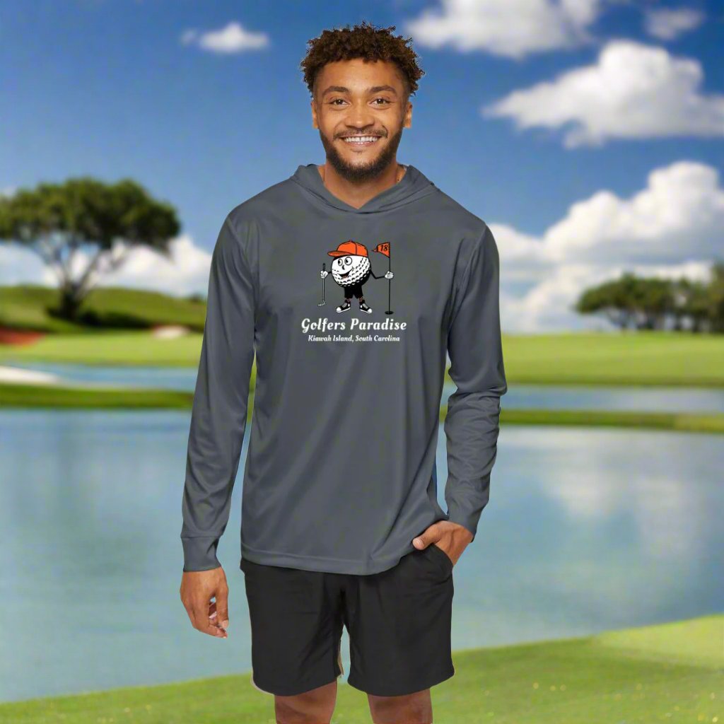 A man wearing a gray golf performance hoodie with long sleeves, celebrating Kiawah Island South Carolina, standing on a golf course in South Carolina.
