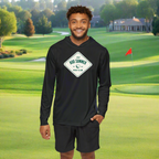A man wearing a black golf performance hoodie with a text logo on the front standing on a golf course.